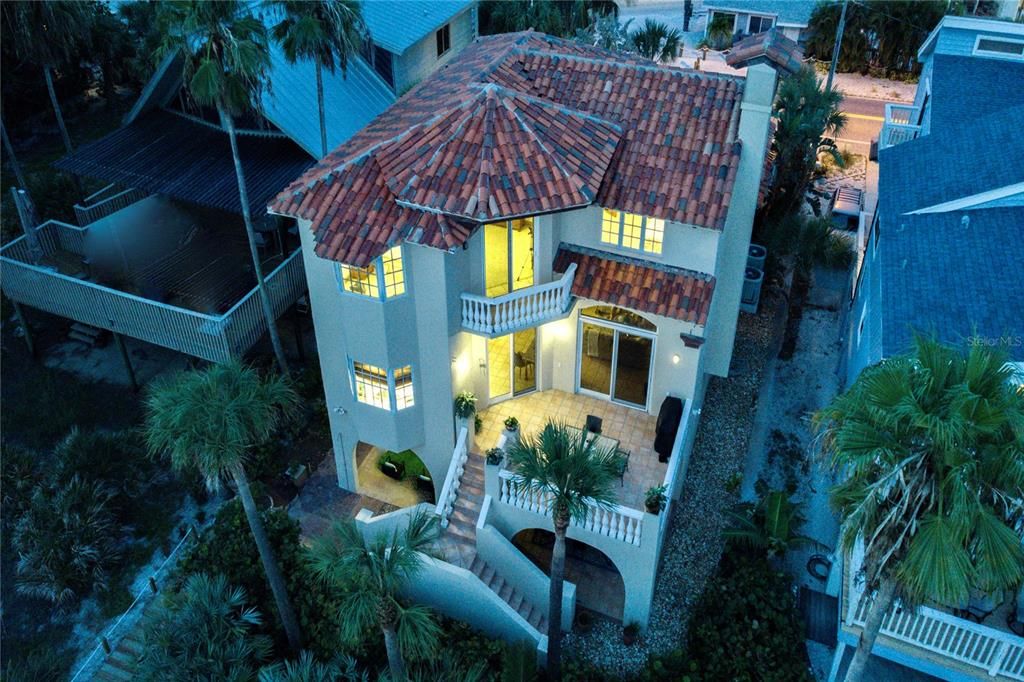 Romantic and beautifully designed dual staircase leads from the spacious terrace on main living level to the beach.