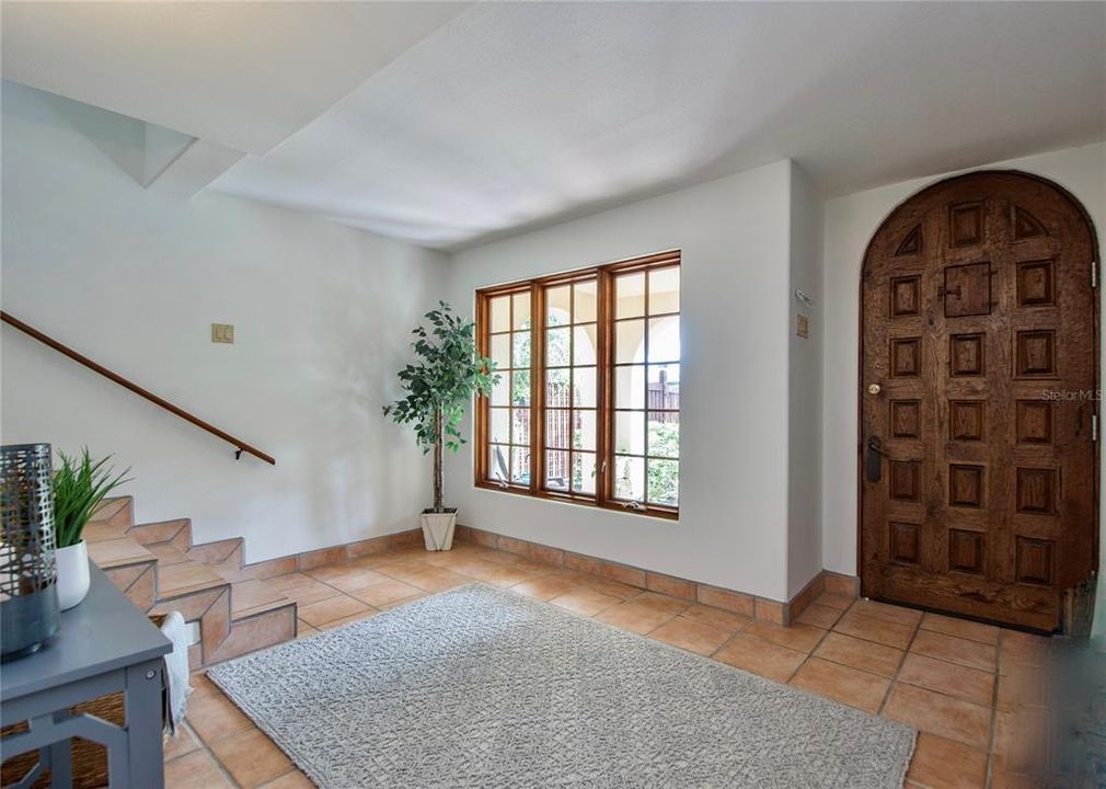 An imported solid heavy oak rustic arched main entry door welcomes you home and leads from the exterior porch to a proper foyer on the ground floor