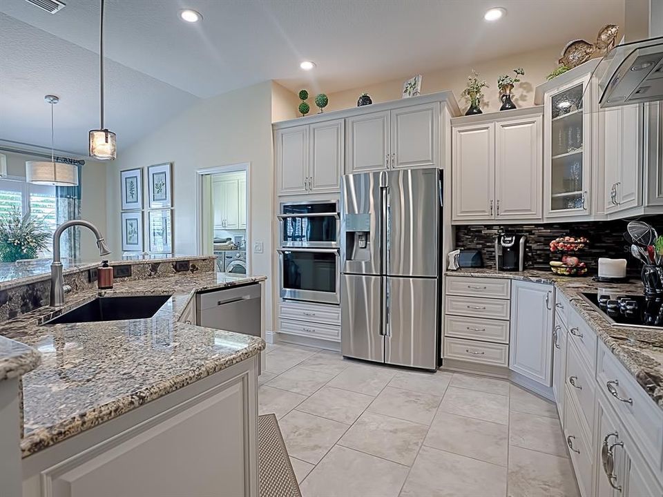 GORGEOUS GRANITE COUNTERTOPS WITH LOVELY TOP-OF-THE-LINE SOFT CLOSE KITCHEN CABINETS WITH LOVELY CUSTOM NICKEL HARDWARE!