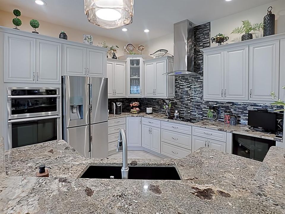 WALL MICROWAVE (CONVECTION TOO) AND WALL OVEN!  BEAUTIFUL GLASS MOSAIC BACKSPLASH THAT EXTENDS UP THE WALL BEHIND THE STAINLESS HOOD! SMOOTH TOP ELECTRIC COOK TOP!