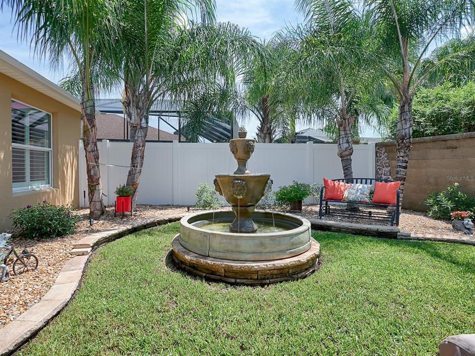 DOUBLE PALMS PROVIDE A RELAXING SPACE TO ENJOY THIS STUNNING FOUNTAIN! GORGEOUS LANDSCAPING AND FABULOUS LIGHTING AROUND THE ENTIRE OUTDOOR AREA!
