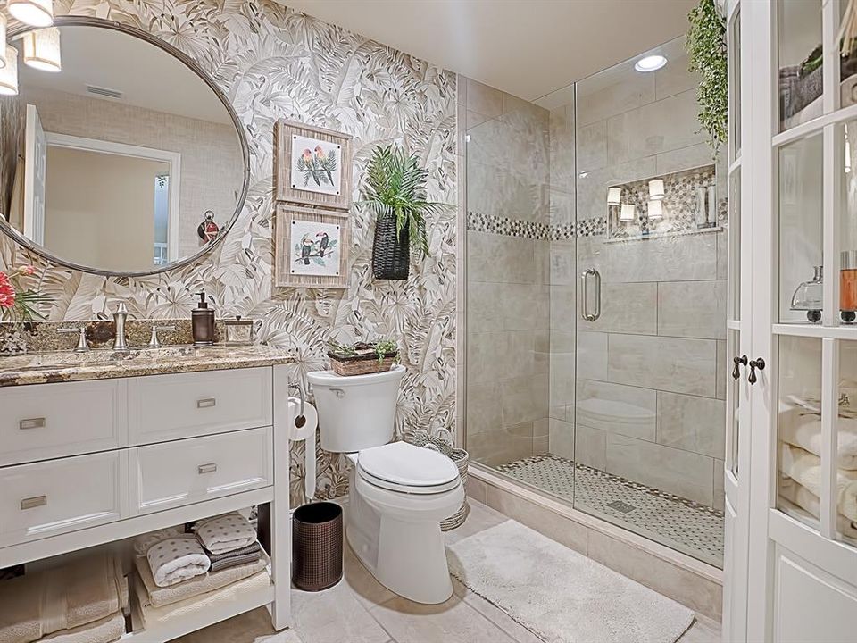 LOVELY REMODELED GUEST BATHROOM WITH FRAMELESS GLASS SHOWER DOOR AND BEAUTIFUL TILE WORK!