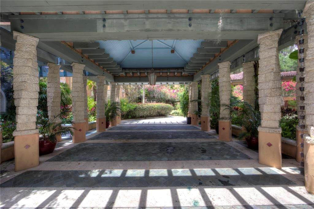 Porte cochere at the entrance featuring cocina columns and hand carved wood working along the perimeter of the ceiling.