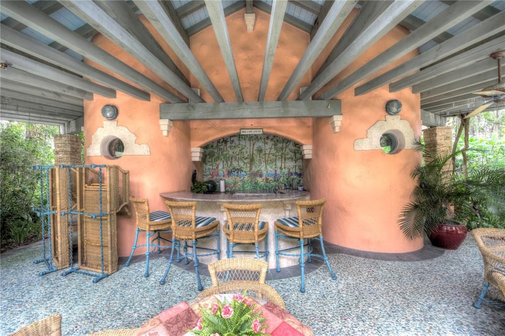 Outdoor kitchen.  The tile mosaic behind the bar replicates the view from that site looking west before the improvements were built.