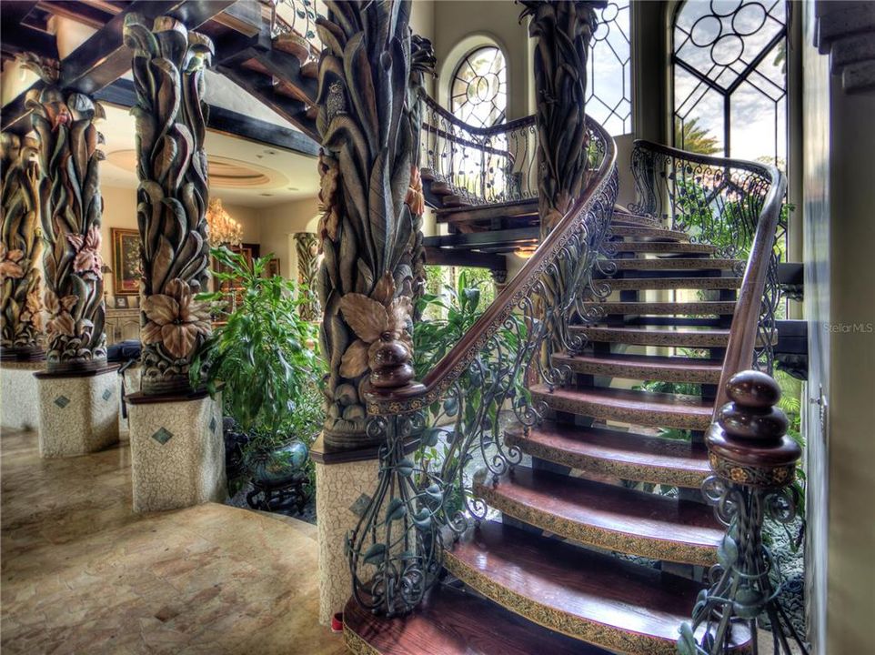 Custom built stairway featuring handcarved Nara wood from the Phillipines.