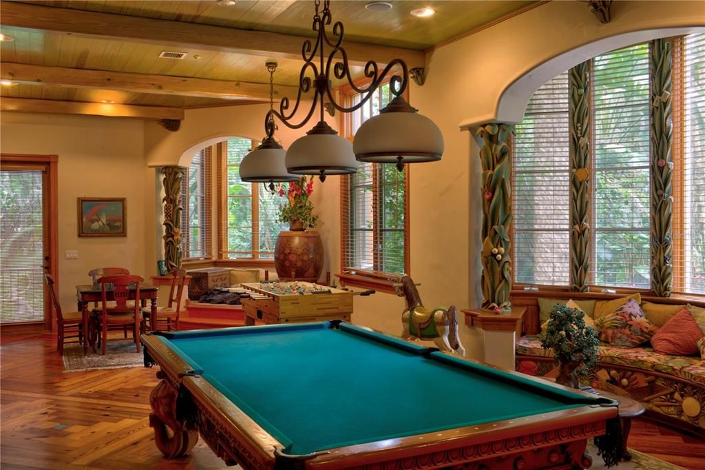 Game Room with billards and chess.  Cozy spaces for reading or overlooking the resort style pool area.  More carvings with game oriented features.