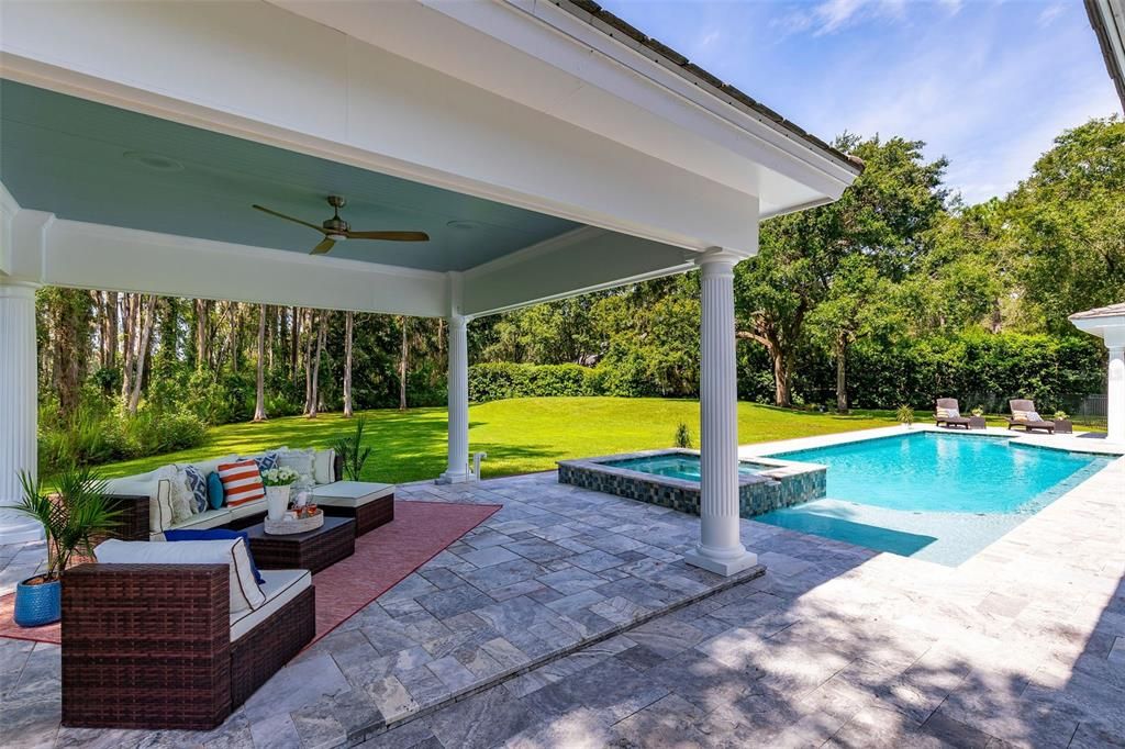 An outdoor living room in this 16 x 16  pool-side pavilion