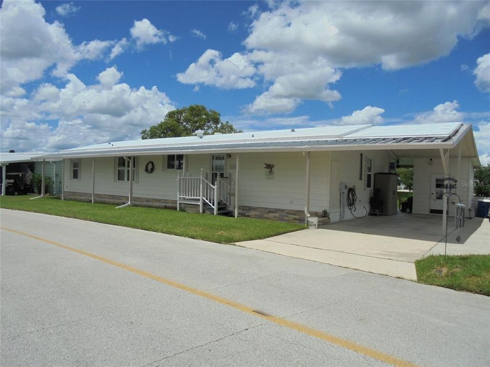 Front view.  House sits lengthwise on the lake.