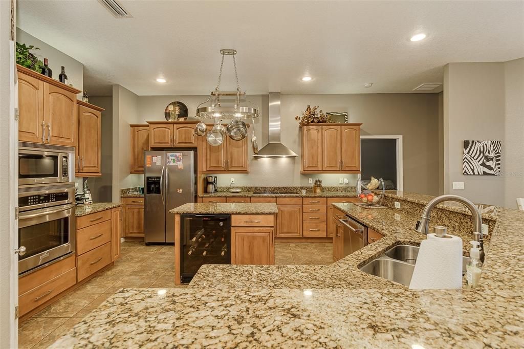 Kitchen with Granite and Island with Wine Fridge