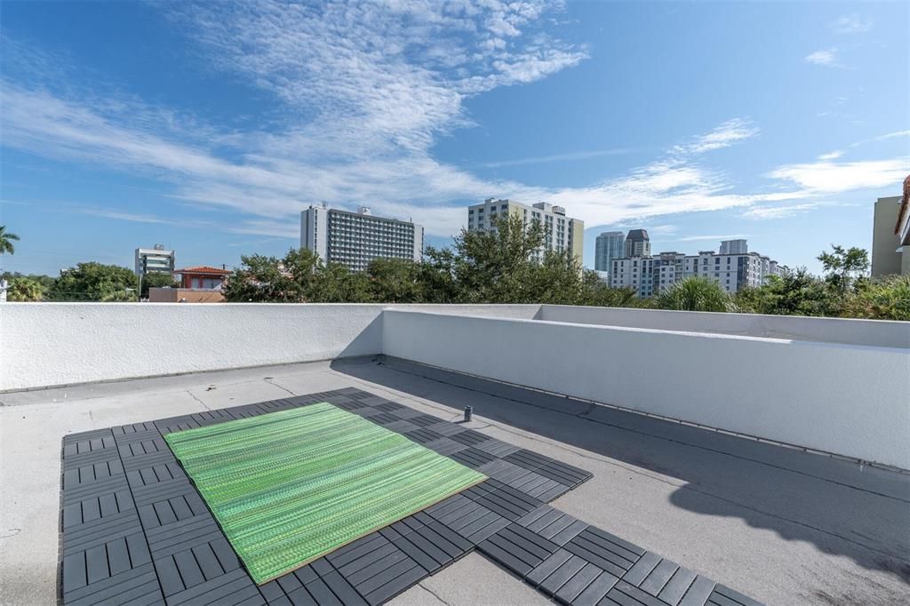 Terrace view looking towards waterfront towers. The tile are a special design and allow the rainwater to flow through and off the roof. You could use them across the complete roof if you wanted - However much space you want to actively use!