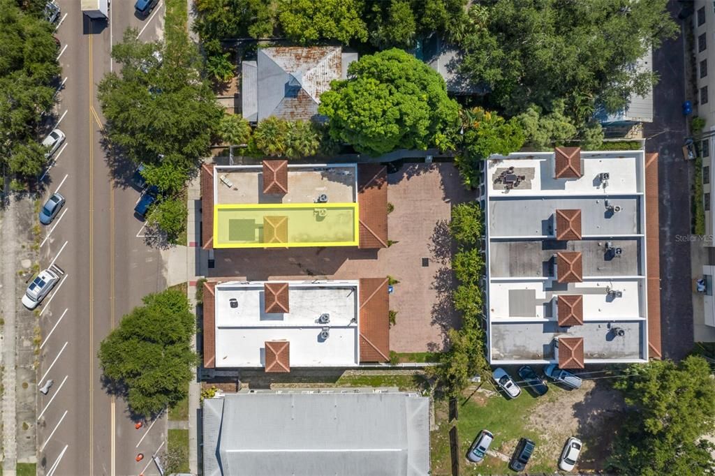 A direct above aerial view. Note - you can see the roof tiles laid out on a couple other units. Also note there is nice space, and trees between the front and back townhome rows, so its not tight maneuvering your vehicle into your garage. There is also ample street parking nearby for guests.