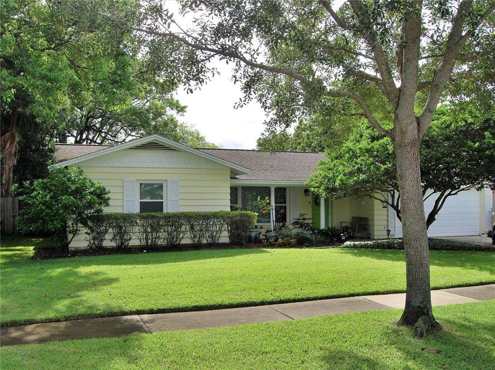 Front Elevation features this beautiful block home. The awnings have just been professionally replaced with Hardie Board Shake shingle look.