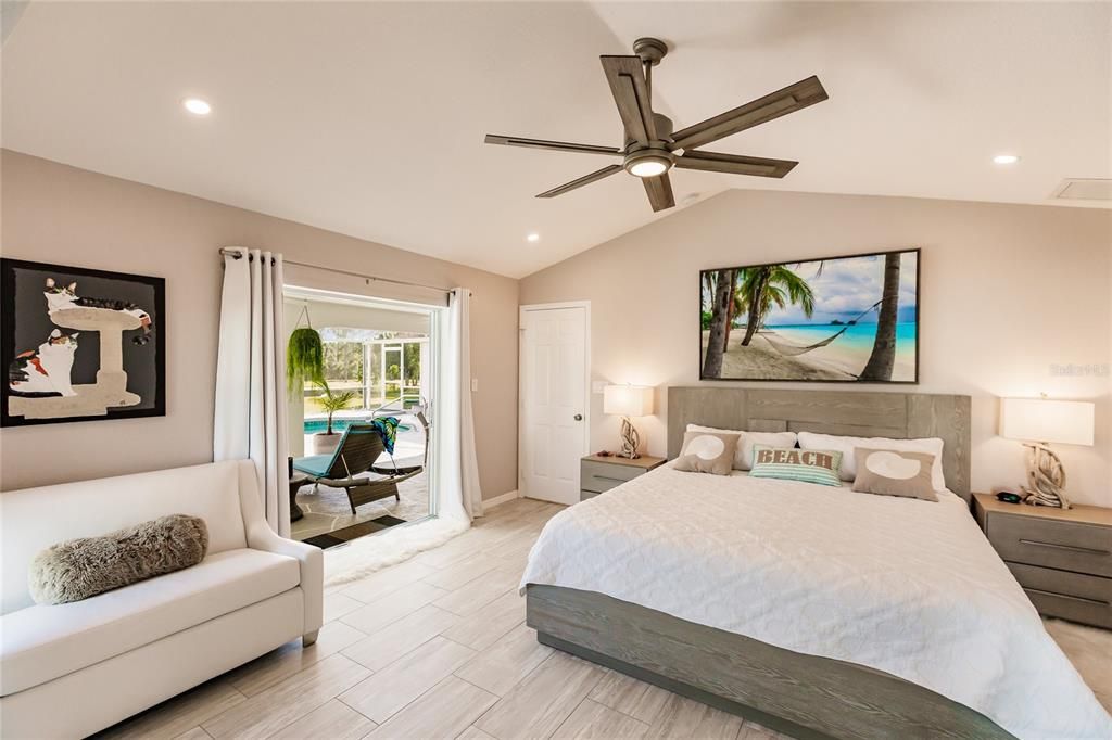 THE EAST WING MASTER SUITE FEATURES VAULTED CEILINGS, GLASS SLIDERS TO LANAI, TV NOOK, AND HIS & HERS WALK IN CLOSETS WHILE THE MASTER BATH INCLUDES 2 SEPARATE VANITIES WITH WALK-IN SHOWER & CHANGING AREA.