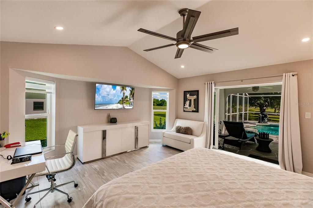 THE EAST WING MASTER SUITE FEATURES VAULTED CEILINGS, GLASS SLIDERS TO LANAI, TV NOOK, AND HIS & HERS WALK IN CLOSETS WHILE THE MASTER BATH INCLUDES 2 SEPARATE VANITIES WITH WALK-IN SHOWER & CHANGING AREA.