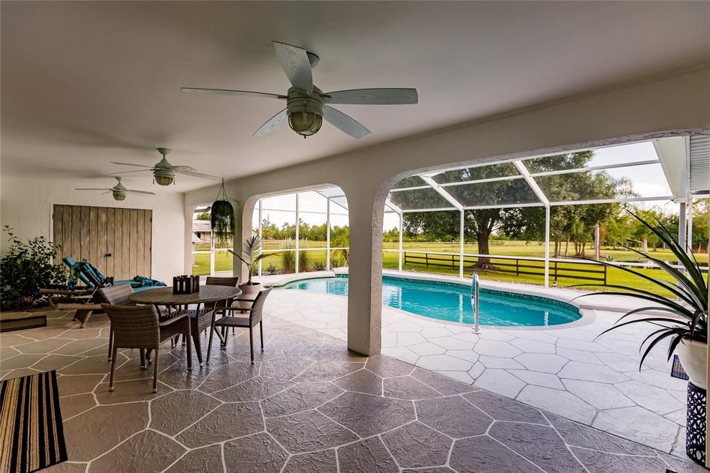 RESURFACED POOL DECK AND LANAI WITH WONDERFUL VIEWS OF THE SENIC ACREAGE & POND.