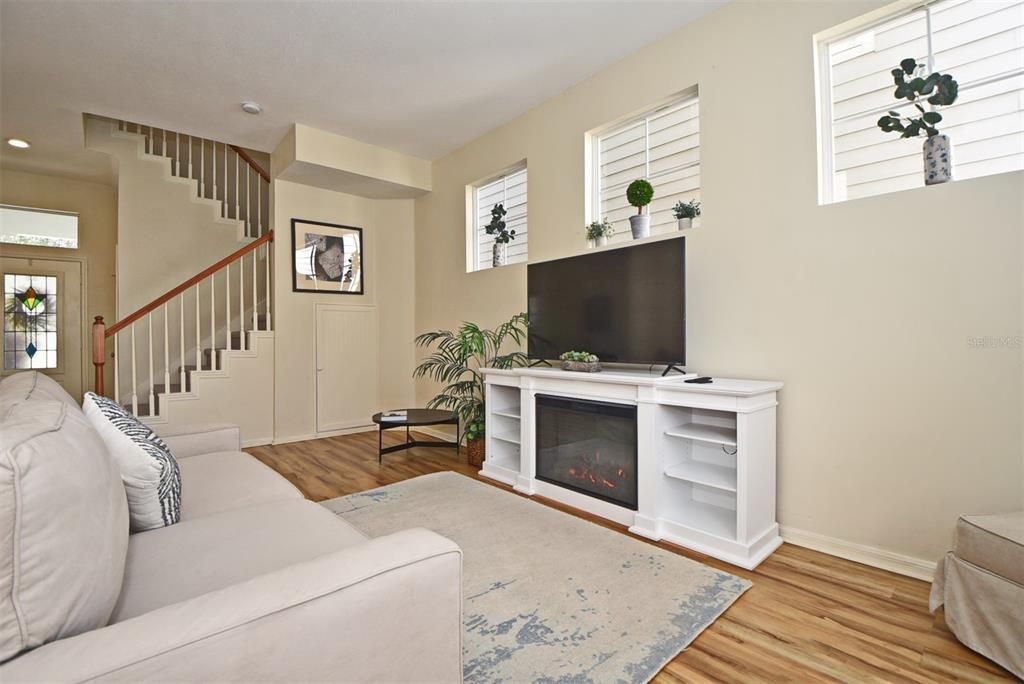 Living Room has closet under stairs for storage