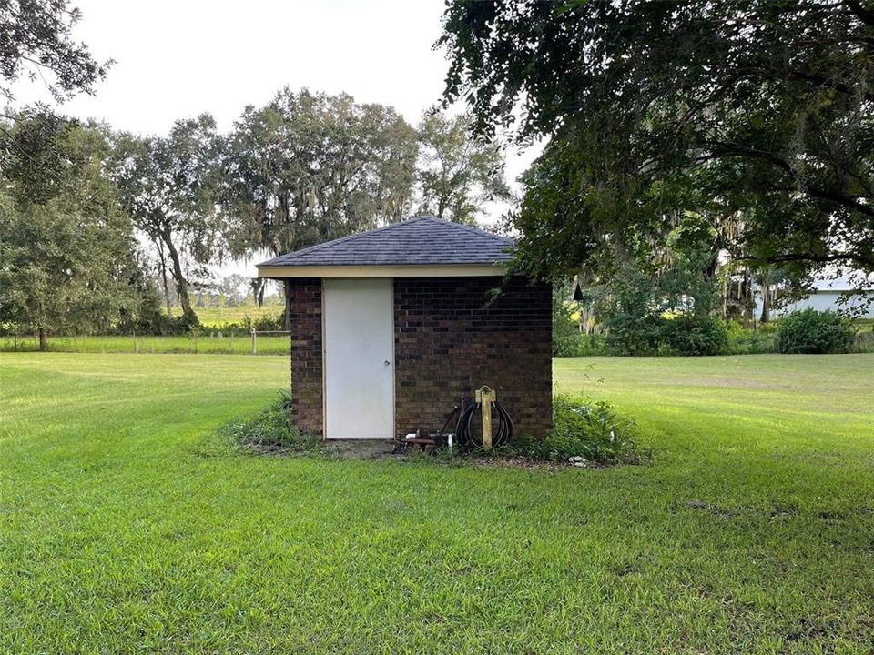 Well/pump house beside pool and driveway