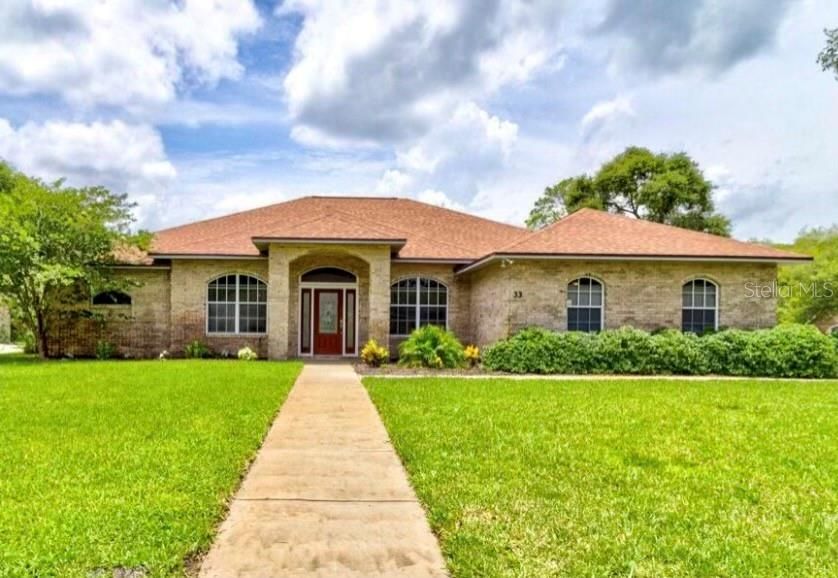 Stately front view of the Beautiful Brick Home