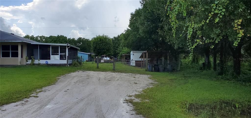 Shell Driveway with extra wide gate for vehicle access to back yard