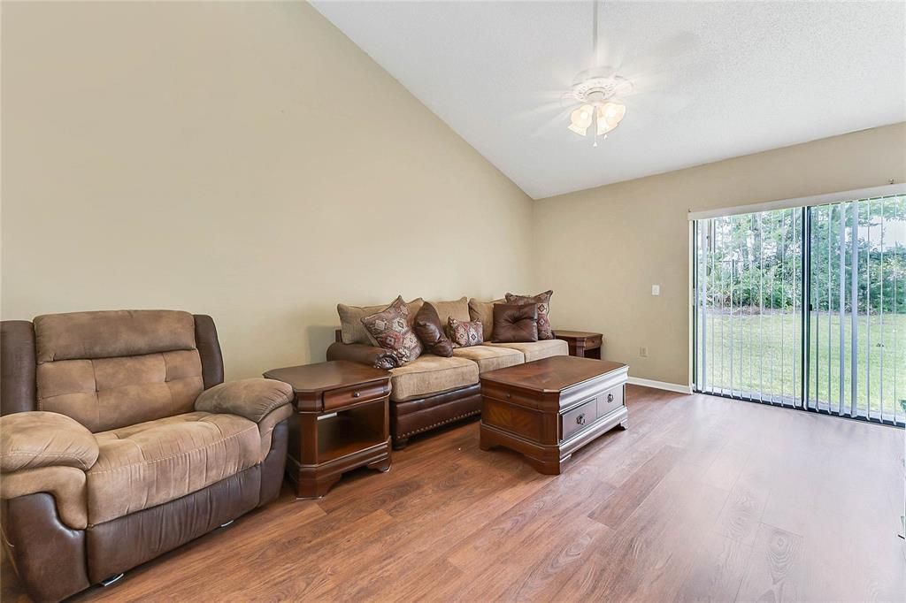 Living room, hardwood floors, sliding door to back yard.