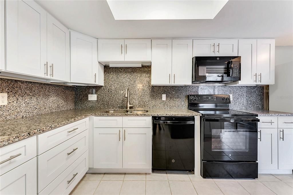 Recently remodeled kitchen with granite countertops and backsplash & soft-close shaker cabinets