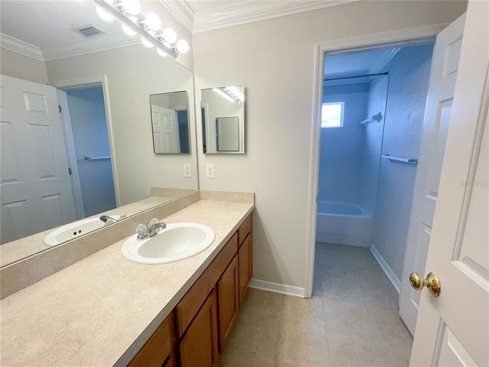 full bathroom upstairs with a tub