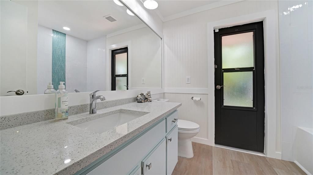 Beautiful sparkle quartz and luxury vinyl flooring with updated faucets and light will wow all the guest in this home