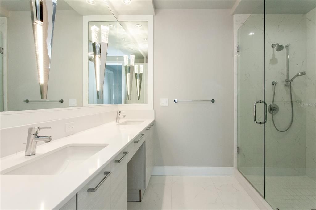 Dual Sinks in the Primary Suite, Huge Walk in Shower and private water closet with frosted glass door.