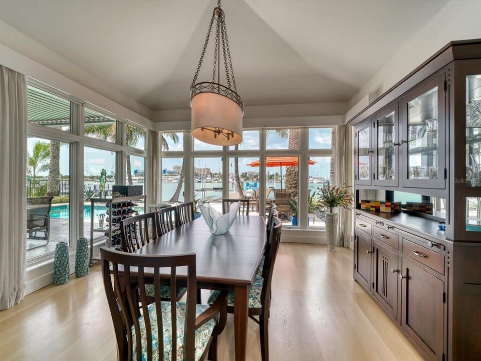 Spacious dining area overlooks fenced yard and pool.