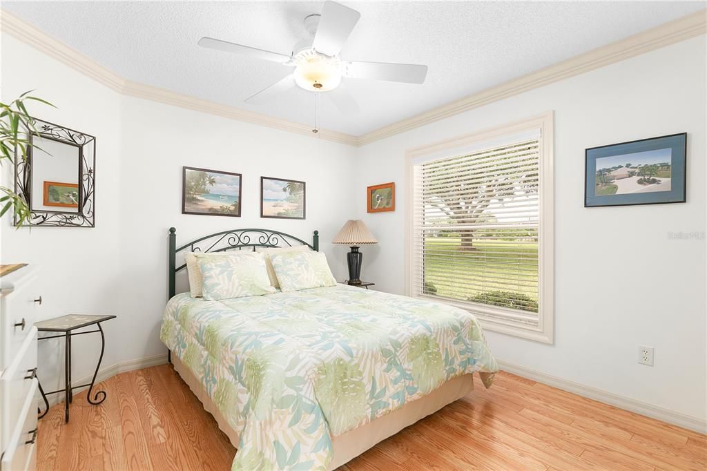 Very Comfortable Guest Bedroom with A View. Notice the Crown Molding and Laminate Flooring.