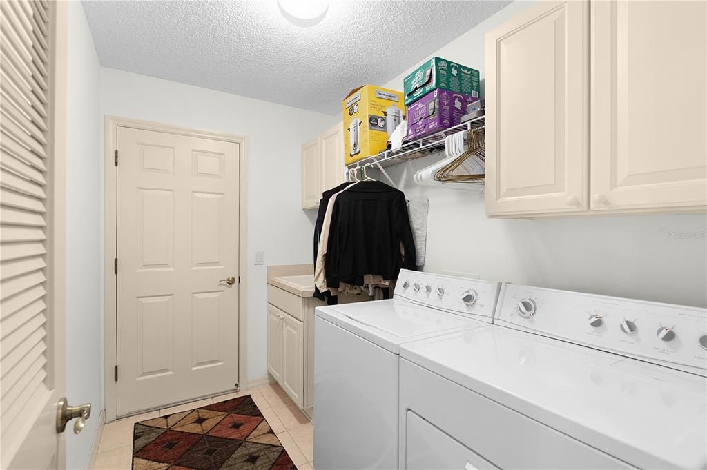 Extra Storage Cabinets and A Soaking Sink in The Laundry Room. Leads out to the Huge 2 Car Garage and Room For 2 Golf Cars.