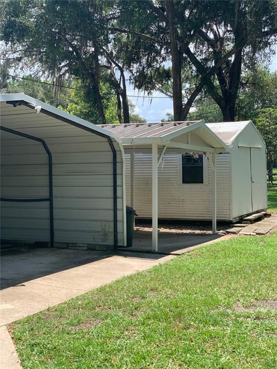 3 carports and two sheds in front