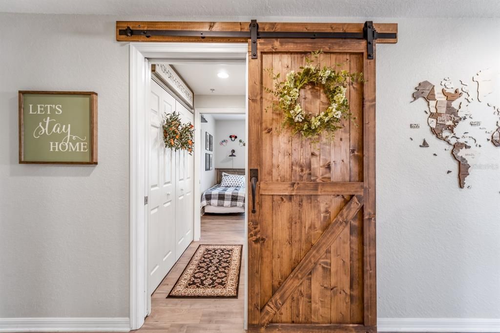 Custom barn door; Additional pocket door closes off guest suite.