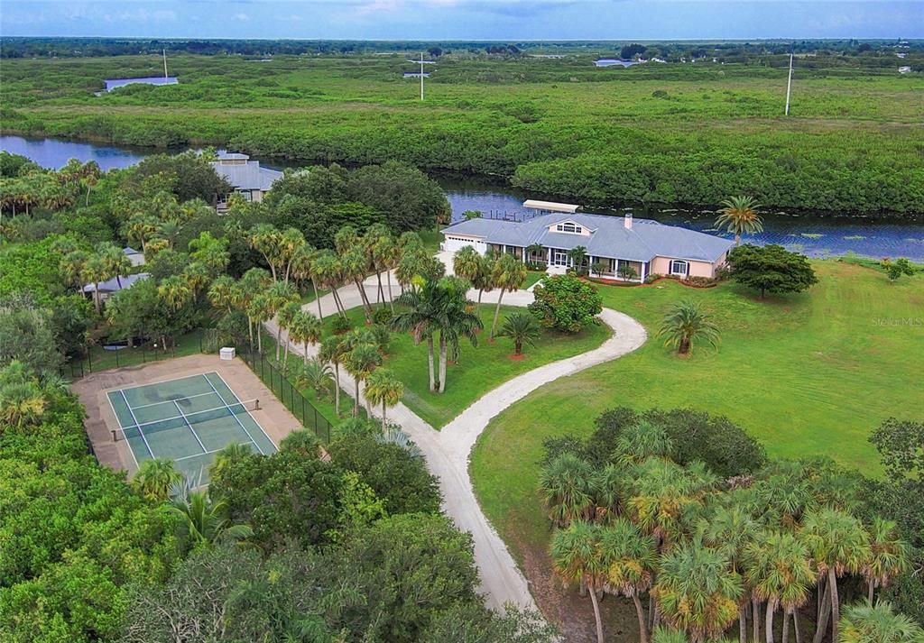 PRIVATE AND PEACEFUL SLICE OF HEAVEN! THIS STUNNING FLORIDA ESTATE IS LOCATED ON OVER 4 ACRES WITH 278’ OF WATER FRONTAGE WITHIN A FEW MILES OF DOWNTOWN PUNTA GORDA!