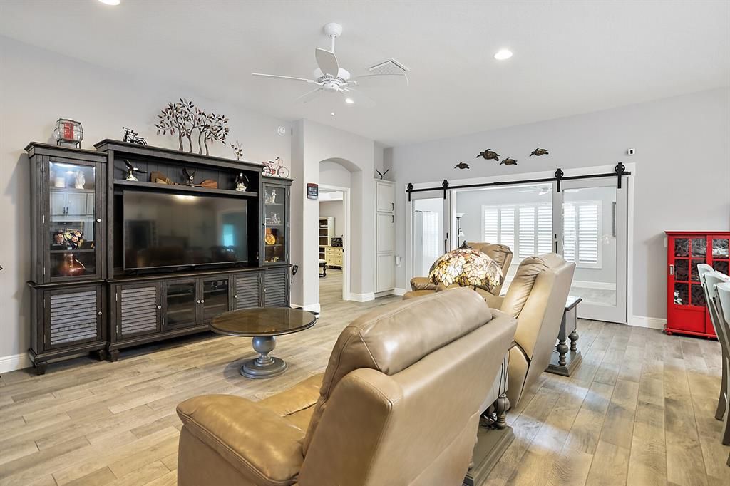 Living area with custom barn doors with access to Florida room