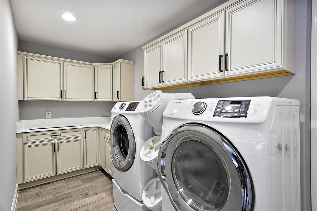 Laundry room with utility sink, quartz countertops & extra cabinets