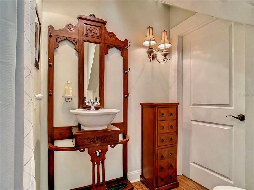 First floor guest bath (accessible from pocket door of guest suite AND foyer) Has an oversized step in shower with tile surround