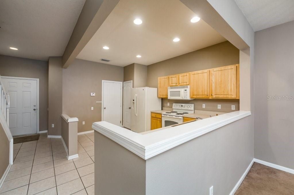 Beautiful view of the kitchen showing the ceramic tile floors and breakfast bar area