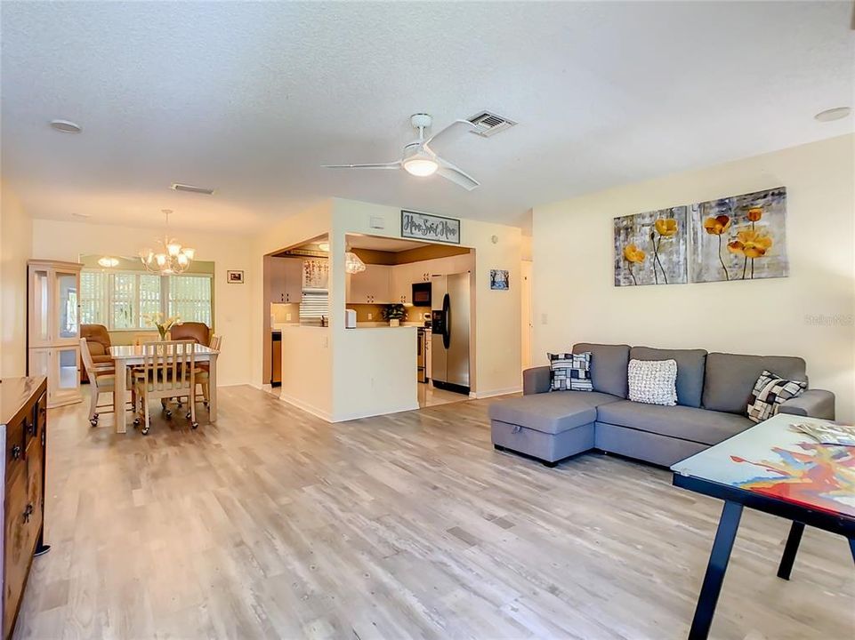 THE OPEN FLOOR PLAN INCLUDES DINING AREA AND A VIEW INTO THE KITCHEN
