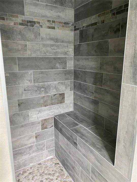 Custom tile walk-in shower in master suite.
