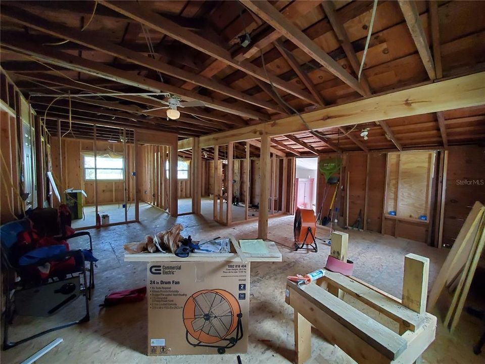 View from open living room looking at framing for master and second bedroom.  Kitchen is through the open doorway