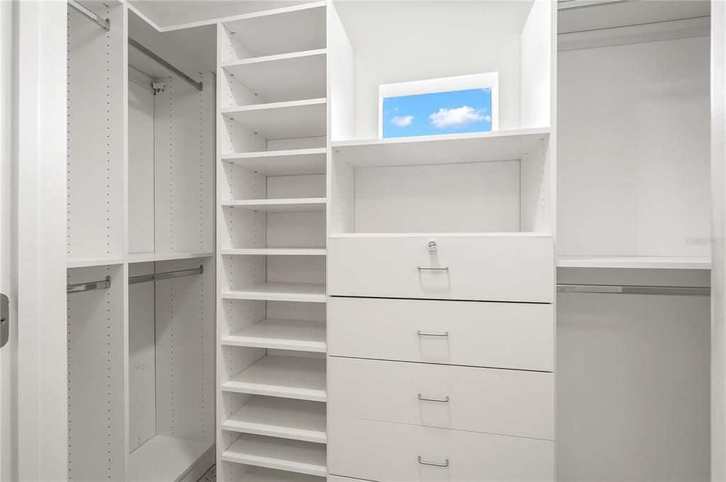 Professionally installed closet organization in the master walk in closet.
