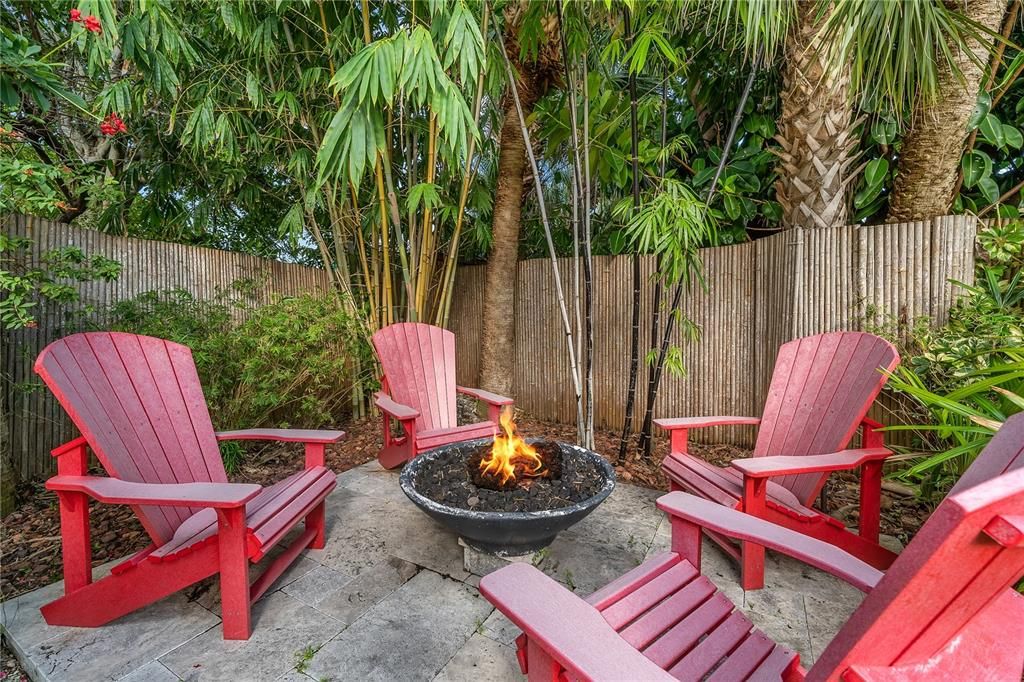 Gas fire pit with custom Adirondack chairs.