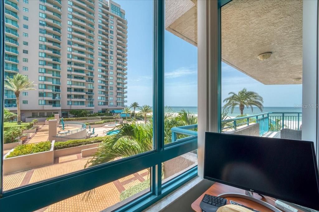 View of the Gulf waters and pool from guest bedroom.  Working from  home is a breeze! This room has double closets, a walk in and a hidden owner's closet!!