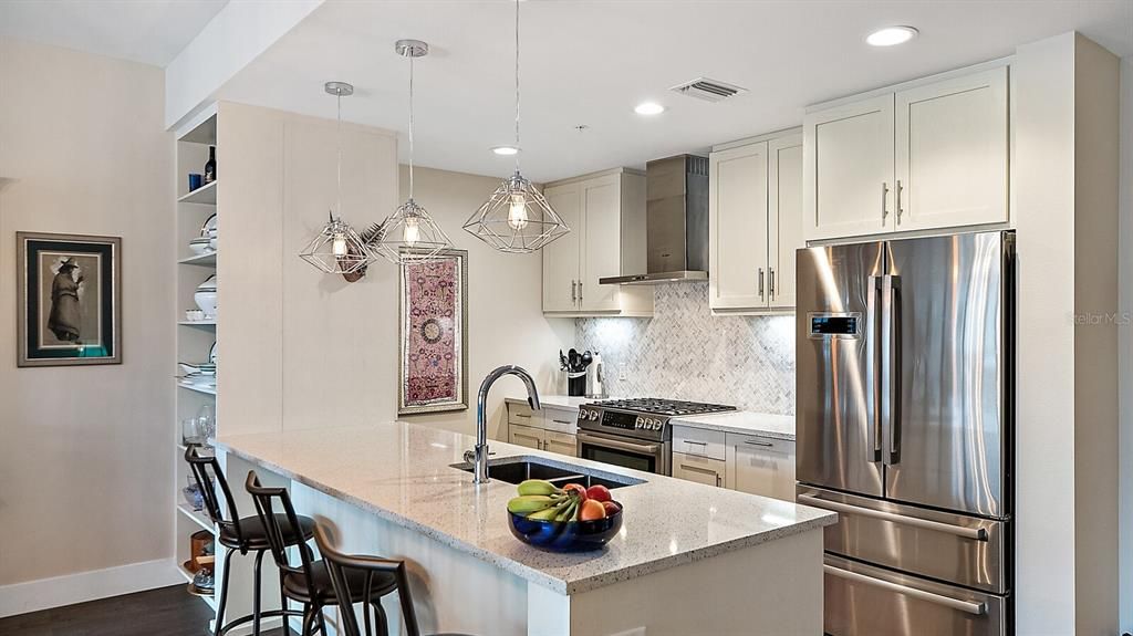 Kitchen features Quartz Counter tops, Gas Range and Bosch Appliances.