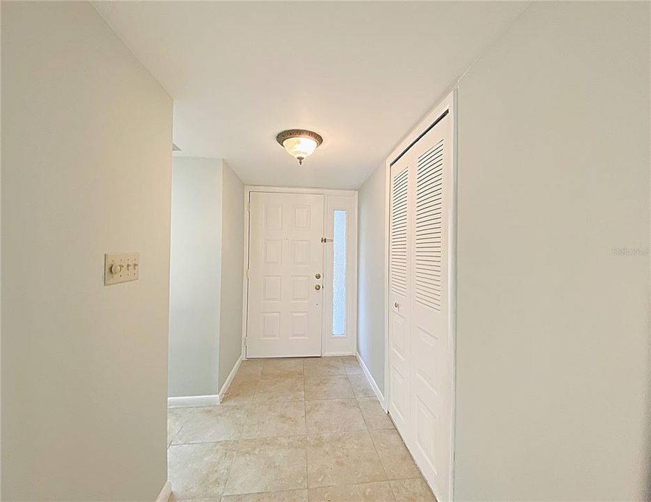 Foyer with kitchen access and coat closet