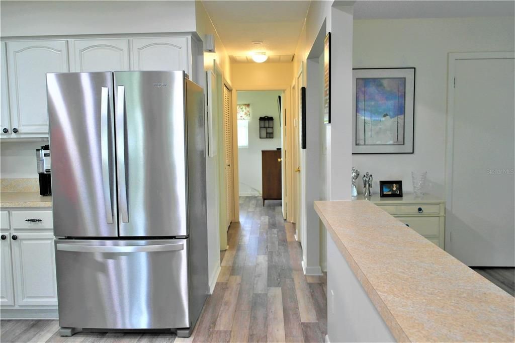 New stainless steel refrigerator & white cabinets for a clean look_121 Heather Lane, Lake Placid