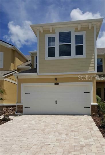 Beautiful pavers lead into the 2 car garage