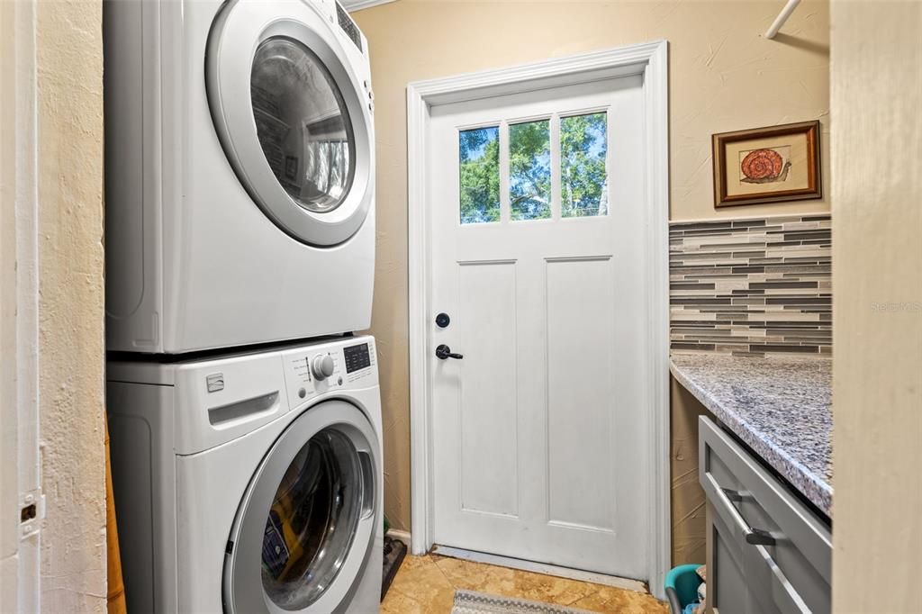 Inside laundry with extra storage and side yard access.