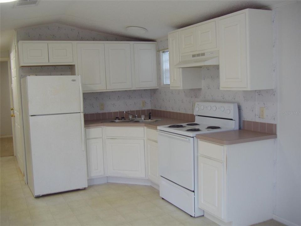 Fully functional kitchen.  A lot of cabinets in this home plus a double stainless sink